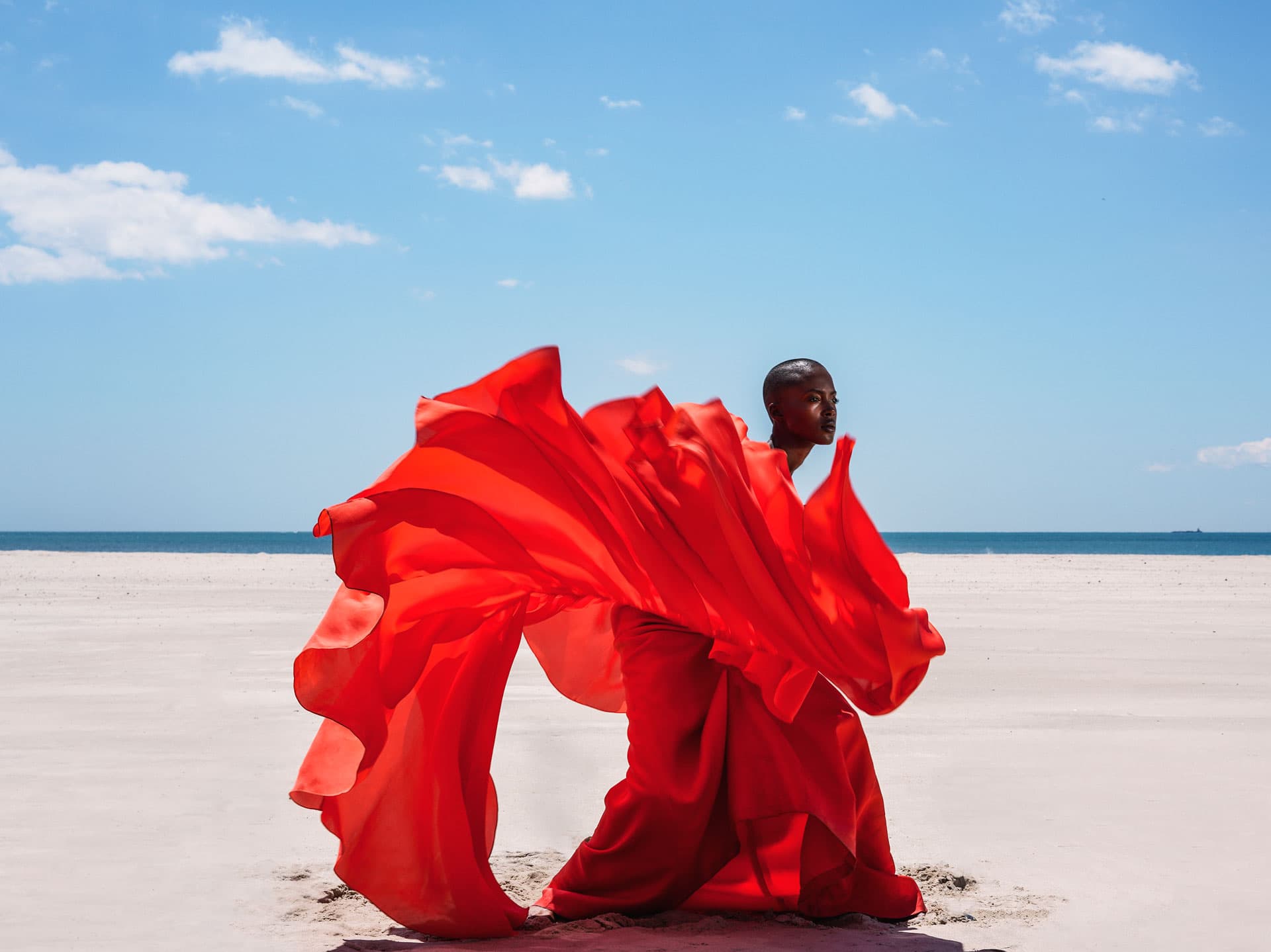 Woman in red dress on beach