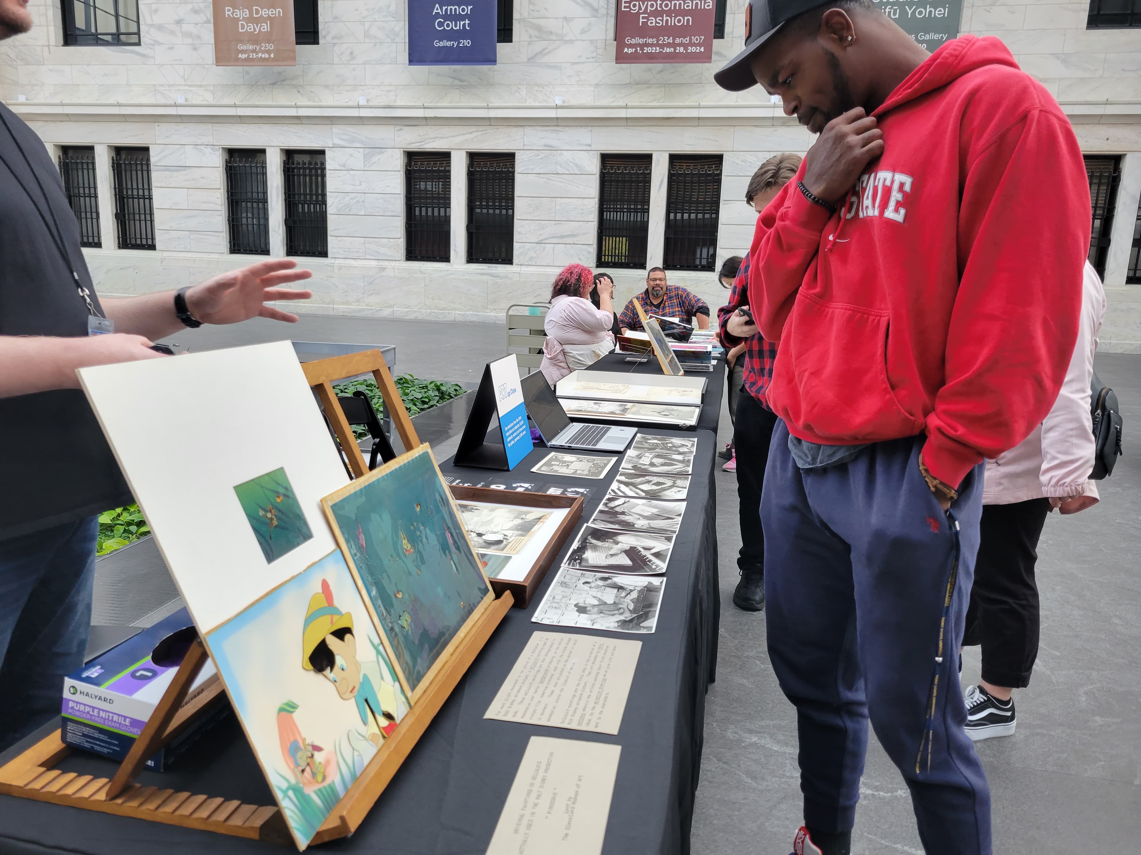 A visitor looking at Education Art objects in the atrium