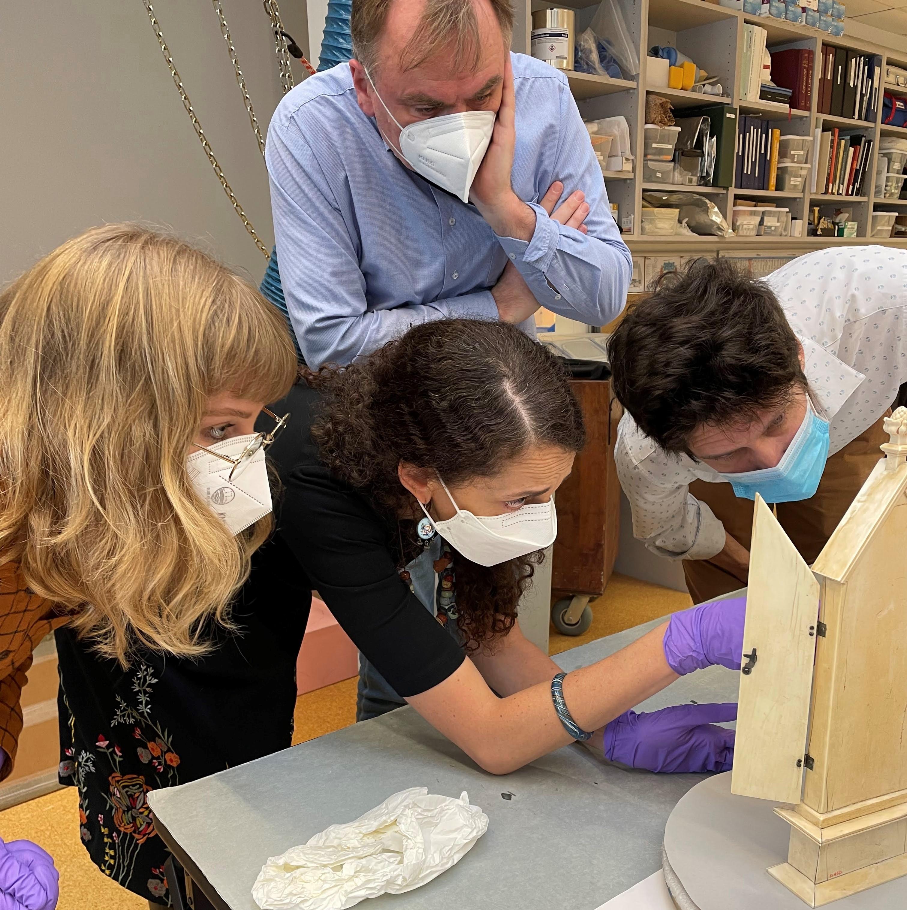 Students and professors crowded around an art object